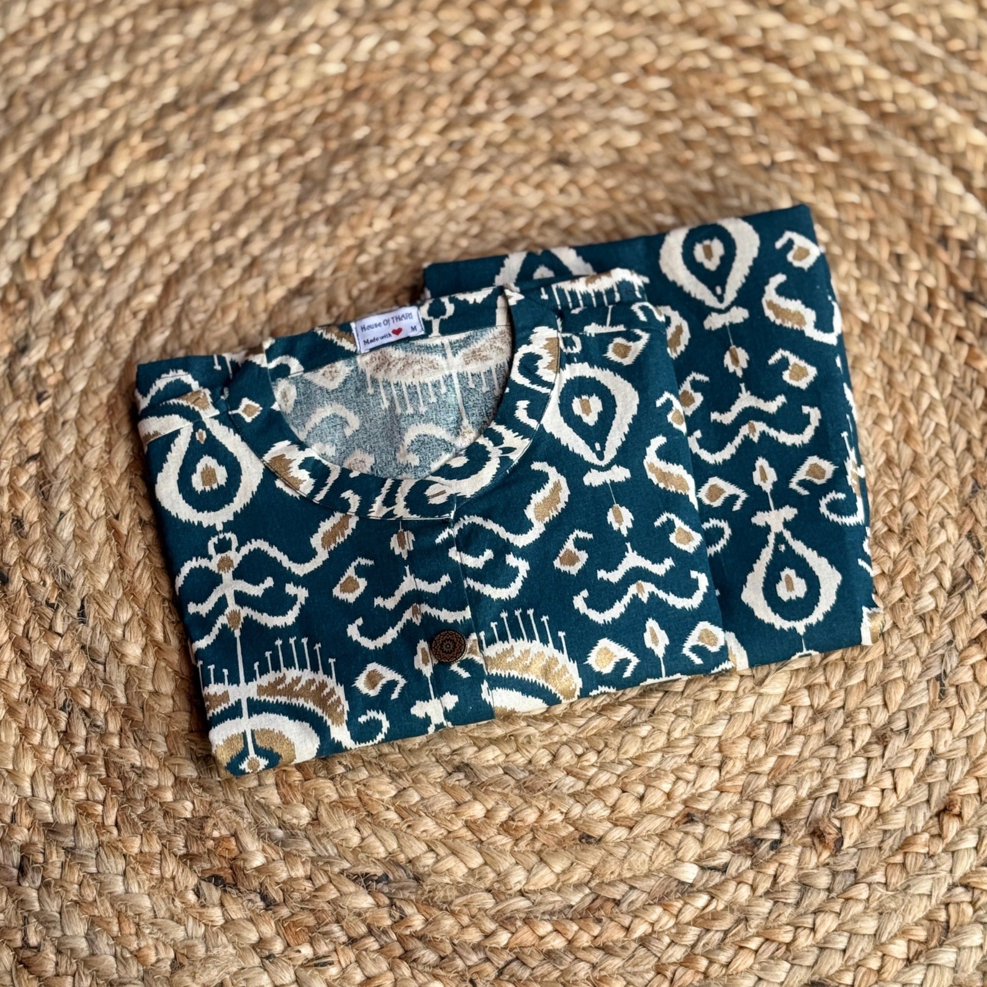 Two blue patterned pouches on a woven mat